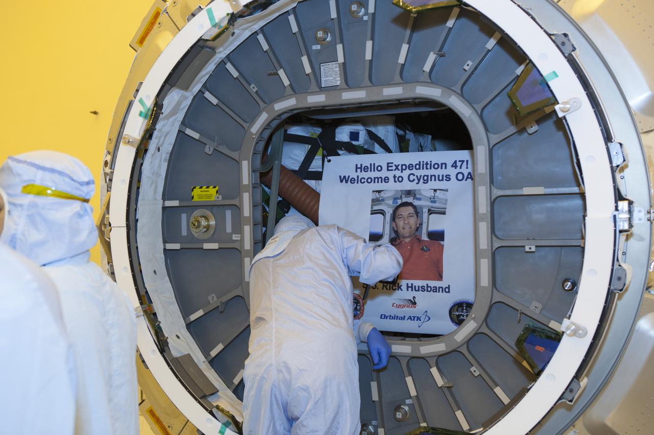 Inside the Payload Hazardous Servicing Facility at NASA's Kennedy Space Center in Florida, the hatch is closed for the upcoming flight of a Cygnus cargo vessel. The spacecraft is scheduled for the upcoming Orbital ATK Commercial Resupply Services-6 mission to deliver hardware and supplies to the International Space Station. When members of the ISS Expedition 47 crew open the hatch, they will be greeted with a sign noting the spacecraft was named SS Rick Husband in honor of the commander of the STS-107 mission. On that flight, the crew of the space shuttle Columbia was lost during re-entry on Feb. 1, 2003. The Cygnus is scheduled to lift off atop a United Launch Alliance Atlas V rocket on March 22.