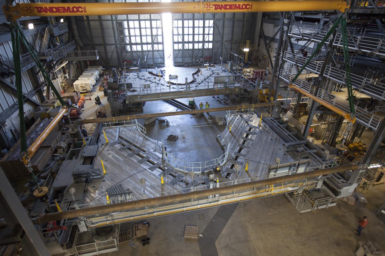 Preparations are underway to lift the second half of the K-level work platforms for NASA’s Space Launch System (SLS) rocket up from High Bay 4 inside the Vehicle Assembly Building at NASA's Kennedy Space Center in Florida. The platform will be lifted up and over the transfer aisle and then lowered into High Bay 3 for installation. It will be secured about 86 feet above the VAB floor, on tower E of the high bay. The K work platforms will provide access to the SLS core stage and solid rocket boosters during processing and stacking operations on the mobile launcher. The Ground Systems Development and Operations Program is overseeing upgrades and modifications to High Bay 3 to support processing of the SLS and Orion spacecraft. A total of 10 levels of new platforms, 20 platform halves altogether, will surround the SLS rocket and Orion spacecraft. 