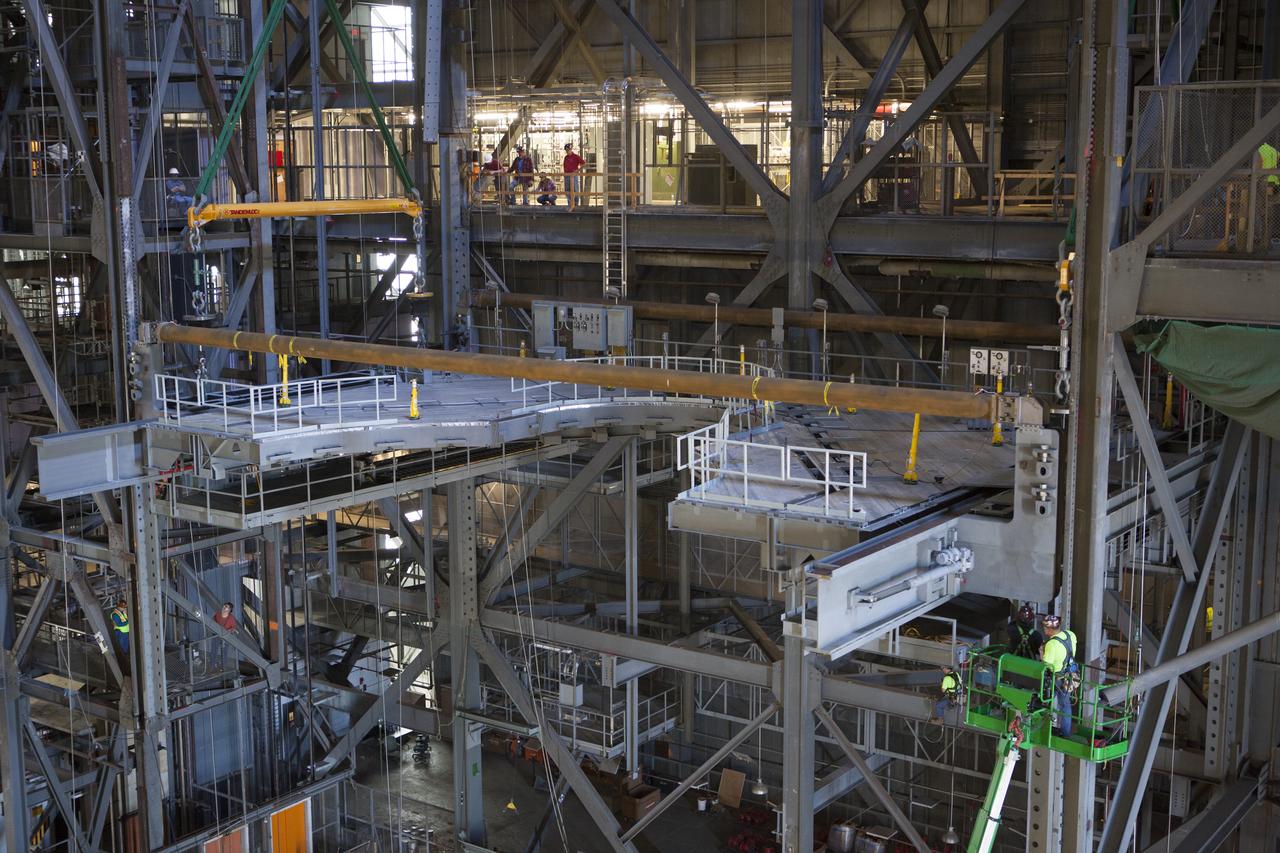 Work is underway to secure the second half of the K-level work platforms for NASA’s Space Launch System (SLS) rocket in High Bay 3 inside the Vehicle Assembly Building at NASA's Kennedy Space Center in Florida. The platform is being secured into position on tower E, about 86 feet above the floor. The K work platforms will provide access to NASA's Space Launch System (SLS) core stage and solid rocket boosters during processing and stacking operations on the mobile launcher. The Ground Systems Development and Operations Program is overseeing upgrades and modifications to High Bay 3 to support processing of the SLS and Orion spacecraft. A total of 10 levels of new platforms, 20 platform halves altogether, will surround the SLS rocket and Orion spacecraft. 