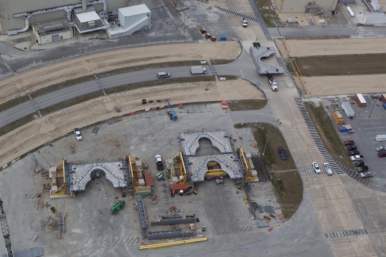 At right, the first half of the F-level work platforms for NASA’s Space Launch System rocket has arrived at the Vehicle Assembly Building at the agency’s Kennedy Space Center in Florida. At left, several other work platforms are being readied for future installation in VAB High Bay 3. The Ground Systems Development and Operations Program is overseeing upgrades and modifications to High Bay 3 to support processing of the SLS and Orion spacecraft. A total of 10 levels of new platforms, 20 platform halves altogether, will surround the SLS rocket and Orion spacecraft and provide access for testing and processing. The first three sets of platforms, H, J and K, were delivered to the center last year. 