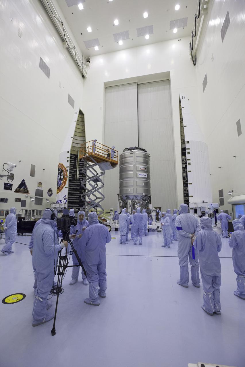 Inside the Payload Hazardous Servicing Facility at NASA's Kennedy Space Center, former NASA astronaut Dan Tani, who now is senior director of Missions and Cargo Operations for Orbital ATK in Dulles, Virginia, participates in a press interview. In the background is the Cygnus spacecraft scheduled to deliver hardware and supplies to the International Space Station on the upcoming Orbital ATK Commercial Resupply Services-6 mission.