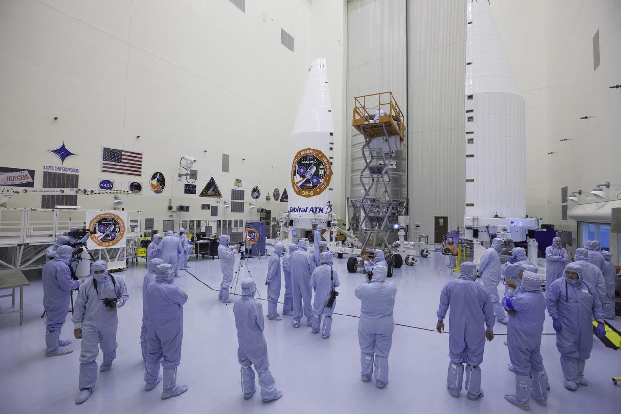 Inside the Payload Hazardous Servicing Facility at NASA's Kennedy Space Center in Florida, members of the news media get a close-up view of a Cygnus cargo vessel. The spacecraft is scheduled for the upcoming Orbital ATK Commercial Resupply Services-6 mission to deliver hardware and supplies to the International Space Station. Reporters, technicians and engineers are clad in "bunny suits." The cleanroom garments are worn to prevent contamination in the controlled environment. The Cygnus is scheduled to lift off atop a United Launch Alliance Atlas V rocket on March 22.