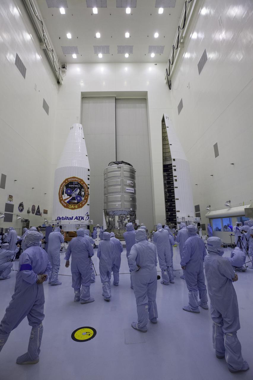 Inside the Payload Hazardous Servicing Facility at NASA's Kennedy Space Center in Florida, members of the news media get a close-up view of a Cygnus cargo vessel. The spacecraft is scheduled for the upcoming Orbital ATK Commercial Resupply Services-6 mission to deliver hardware and supplies to the International Space Station. Reporters, technicians and engineers are clad in "bunny suits." The cleanroom garments are worn to prevent contamination in the controlled environment. The Cygnus is scheduled to lift off atop a United Launch Alliance Atlas V rocket on March 22.