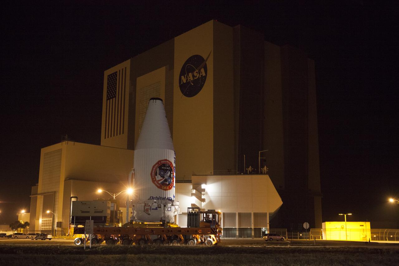 Encapsulated inside its payload fairing, the Cygnus spacecraft for the upcoming Orbital ATK Commercial Resupply Services-6 mission moves past the Vehicle Assembly Building at NASA's Kennedy Space Center in Florida. Mounted atop a KAMAG transporter, Cygnus is being moved to Space Launch Complex-41 at Cape Canaveral Air Force Station where it will be mounted atop a United Launch Alliance Atlas V rocket. The Cygnus is scheduled to lift off atop a United Launch Alliance Atlas V rocket on March 22 to deliver hardware and supplies to the International Space Station.