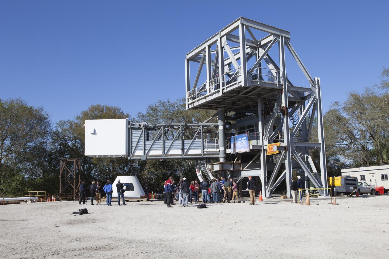 NASA, Boeing and United Launch Alliance officials discuss the Crew Access Arm under construction at a yard near NASA's Kennedy Space Center in Florida. The arm and white room are being built to bridge the space between the Crew Access Tower and the hatch to Boeing's CST-100 Starliner spacecraft as it stands atop a ULA Atlas V rocket at Space Launch Complex 41 before flight. Partnering with NASA's Commercial Crew Program, Boeing is one of two companies building a new, privately owned and operated space system to carry astronauts to the International Space Station. 