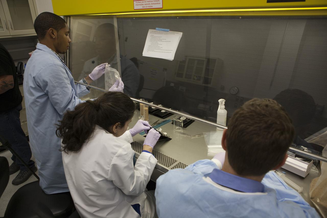 Inside a laboratory in the Space Station Processing Facility at NASA’s Kennedy Space Center in Florida, research scientists prepare the plant pillows for the Veg-03 experiment that will be delivered to the International Space Station aboard the eighth SpaceX Dragon commercial resupply mission. From left, are Matt Romeyn, NASA pathways intern; Dr. Gioia Massa, NASA payload scientist for Veggie; and Dr. Mathew Mickens, a post-doctoral researcher. The Veg-03 plant pillows will contain ‘Tokyo Bekana’ cabbage seeds and lettuce seeds for NASA’s third Veggie plant growth system experiment. The experiment will continue NASA’s deep space plant growth research to benefit the Earth and the agency’s journey to Mars.