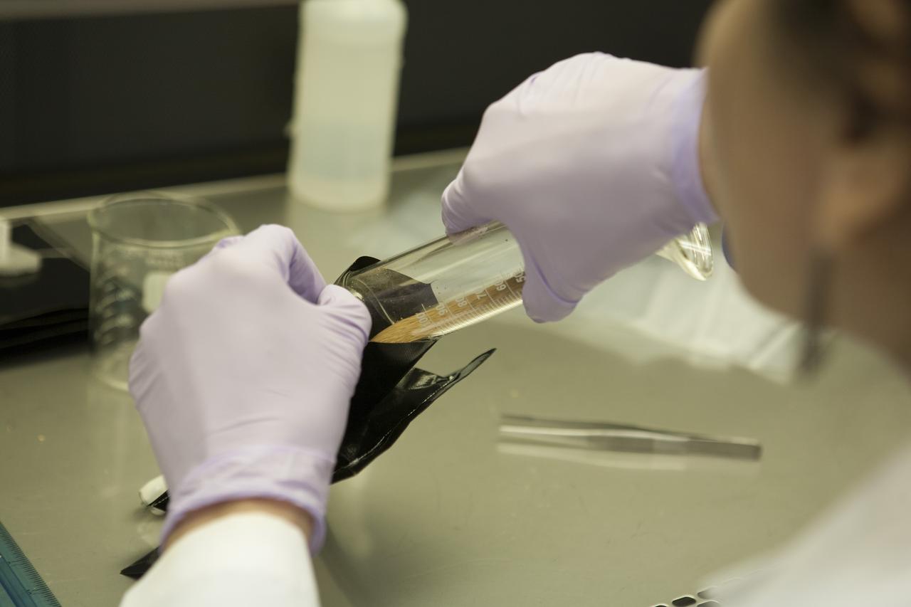 Inside a laboratory in the Space Station Processing Facility at NASA’s Kennedy Space Center in Florida, research scientists prepare the plant pillows for the Veg-03 experiment that will be delivered to the International Space Station aboard the eighth SpaceX Dragon commercial resupply mission. Matt Romeyn, a NASA pathways intern, inserts a measured amount of calcined clay, or space dirt, into one of the plant pillows. The Veg-03 plant pillows will contain ‘Tokyo Bekana’ cabbage seeds and lettuce seeds for NASA’s third Veggie plant growth system experiment. The experiment will continue NASA’s deep space plant growth research to benefit the Earth and the agency’s journey to Mars.