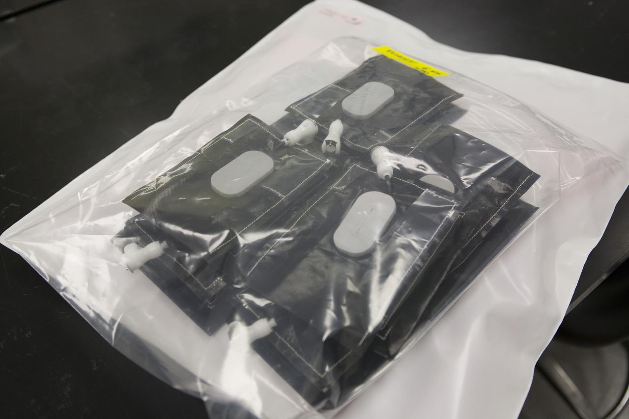 Inside a laboratory in the Space Station Processing Facility at NASA’s Kennedy Space Center in Florida, plant pillows for the Veg-03 experiment are prepared for delivery to the International Space Station aboard the eighth SpaceX Dragon commercial resupply mission. Dr. Mathew Mickens, a post-doctoral researcher, inserts a bonding agent into one of the Veg-03 plant pillows. The Veg-03 plant pillows will contain ‘Tokyo Bekana’ cabbage seeds and lettuce seeds for NASA’s third Veggie plant growth system experiment. The experiment will continue NASA’s deep space plant growth research to benefit the Earth and the agency’s journey to Mars. 