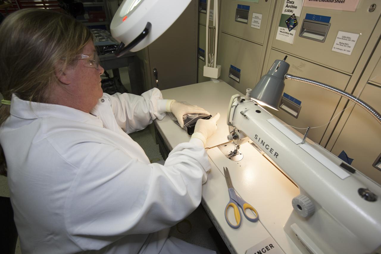 Inside a laboratory in the Space Station Processing Facility at NASA’s Kennedy Space Center in Florida, Michele Koralewicz, a mechanical technician with EASI on the Engineering Services Contract, sews up the end of a bag that contains one of the Veg-03 plant pillows. The Veg-03 experiment will be delivered to the International Space Station aboard the eighth SpaceX Dragon commercial resupply mission. The Veg-03 plant pillows will contain ‘Tokyo Bekana’ cabbage seeds and lettuce seeds for NASA’s third Veggie plant growth system experiment. The experiment will continue NASA’s deep space plant growth research to benefit the Earth and the agency’s journey to Mars. 