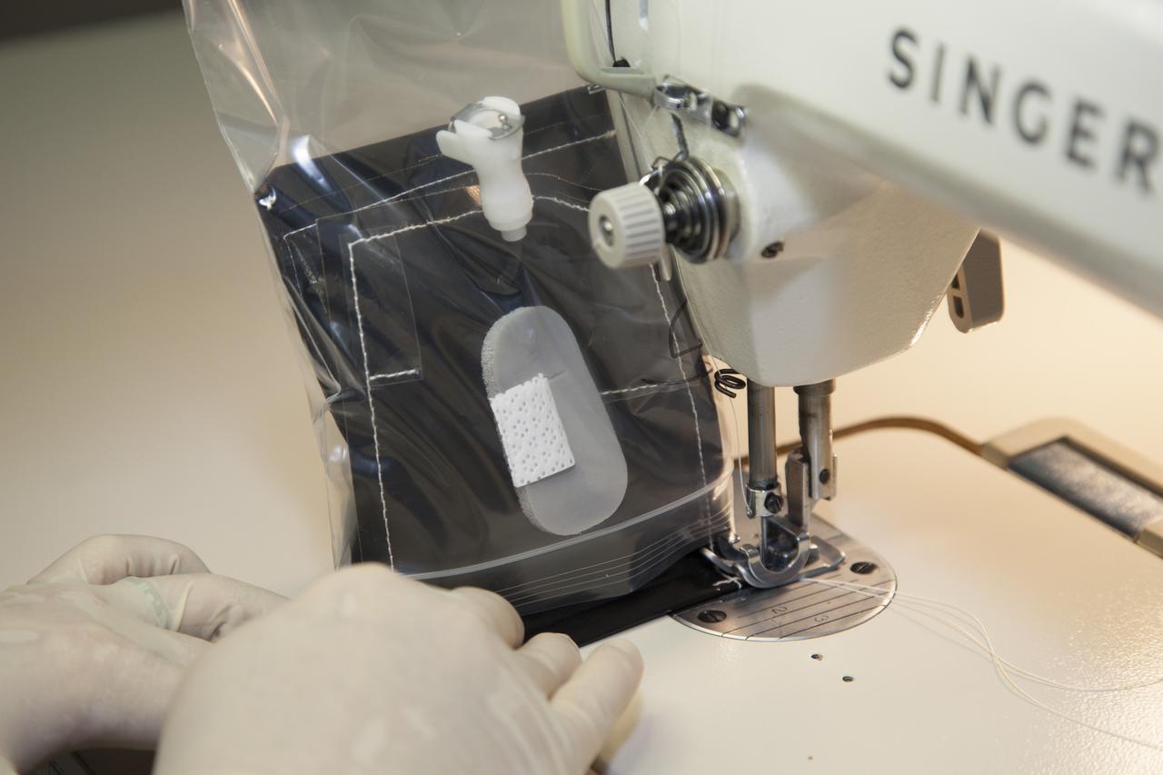 Inside a laboratory in the Space Station Processing Facility at NASA’s Kennedy Space Center in Florida, Michele Koralewicz, a mechanical technician with EASI on the Engineering Services Contract, sews up the end of a bag that contains one of the Veg-03 plant pillows. The Veg-03 experiment will be delivered to the International Space Station aboard the eighth SpaceX Dragon commercial resupply mission. The Veg-03 plant pillows will contain ‘Tokyo Bekana’ cabbage seeds and lettuce seeds for NASA’s third Veggie plant growth system experiment. The experiment will continue NASA’s deep space plant growth research to benefit the Earth and the agency’s journey to Mars. 