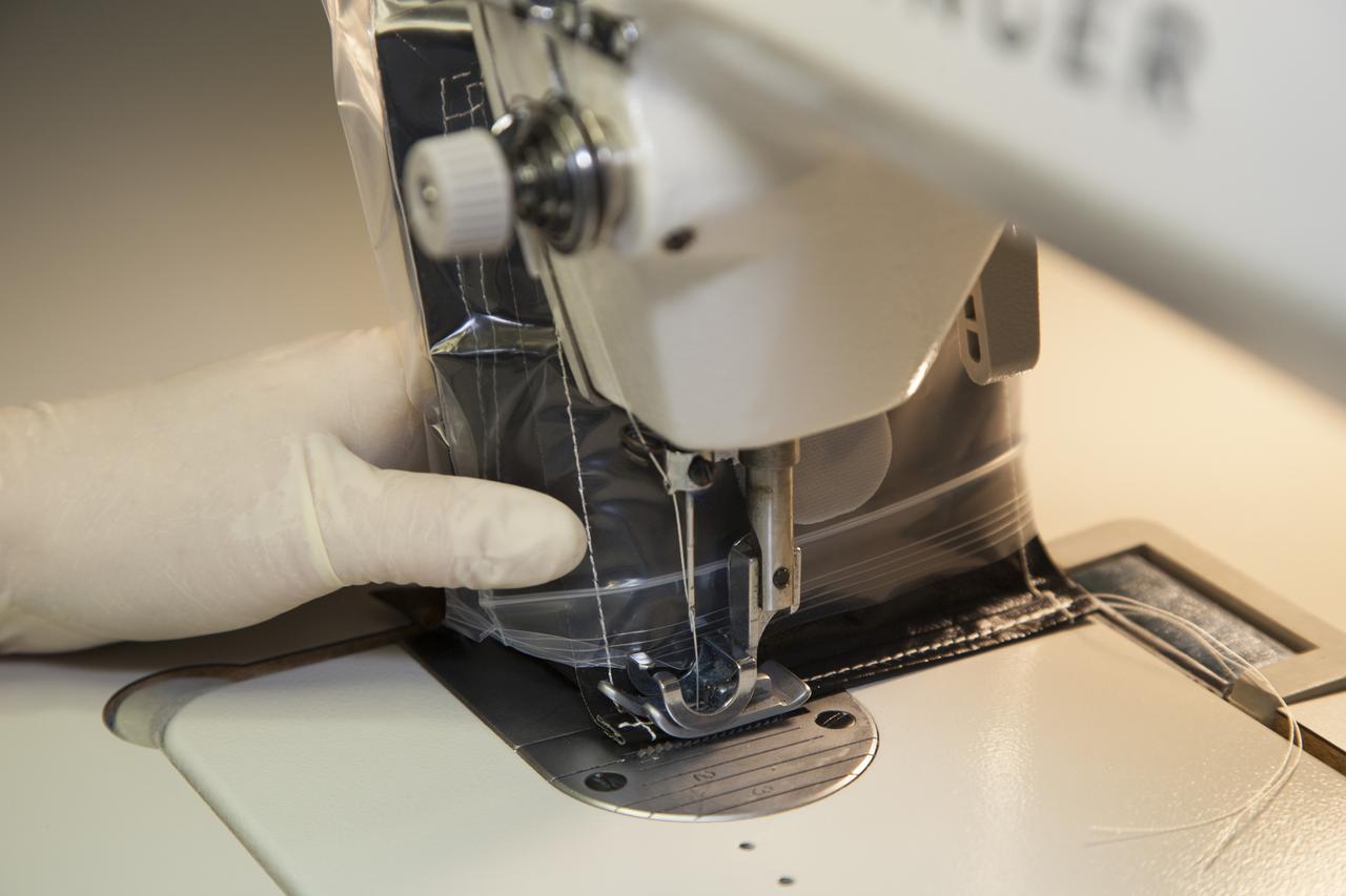 Inside a laboratory in the Space Station Processing Facility at NASA’s Kennedy Space Center in Florida, Michele Koralewicz, a mechanical technician with EASI on the Engineering Services Contract, precisely sews up the end of a bag that contains one of the Veg-03 plant pillows. The Veg-03 experiment will be delivered to the International Space Station aboard the eighth SpaceX Dragon commercial resupply mission. The Veg-03 plant pillows will contain ‘Tokyo Bekana’ cabbage seeds and lettuce seeds for NASA’s third Veggie plant growth system experiment. The experiment will continue NASA’s deep space plant growth research to benefit the Earth and the agency’s journey to Mars.