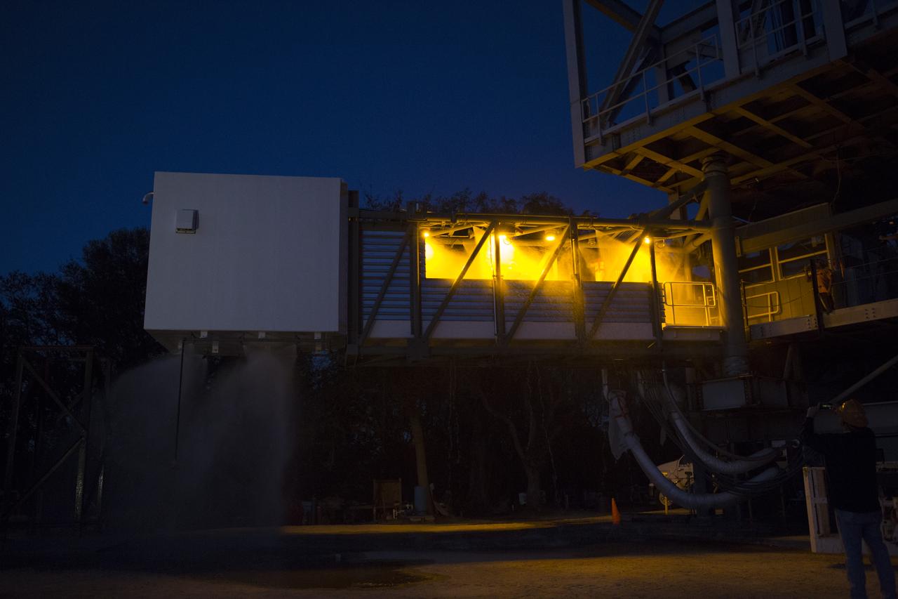 Water sprays on the Crew Access Arm during a deluge systems test March 23 at a construction yard near NASA's Kennedy Space Center in Florida. The arm is being tested before being installed on Space Launch Complex 41 Crew Access Tower later this year. It will be used as a bridge by astronauts to board Boeing's CST-100 Starliner spacecraft as it stands on the launch pad atop a United Launch Alliance Atlas V rocket.
