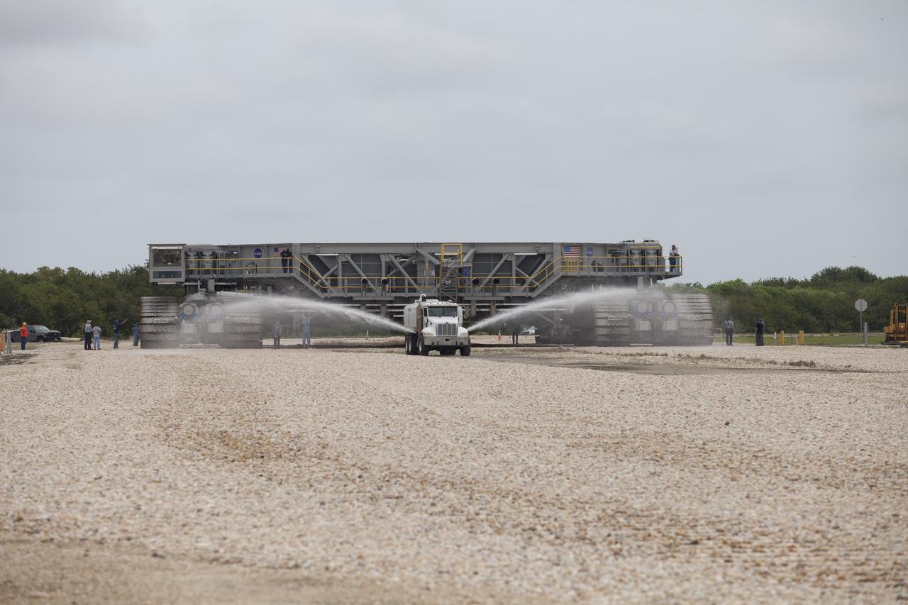 NASA’s upgraded crawler-transporter 2 (CT-2) returns from its trek to Launch Pad 39B at the agency’s Kennedy Space Center in Florida. CT-2 traveled to Pad 39B to test recently completed upgrades and modifications to support NASA’s journey to Mars. A truck sprays water in front of the crawler to control dust as the large vehicle moves along. The Ground Systems Development and Operations Program at Kennedy oversaw upgrades to the crawler in the Vehicle Assembly Building. The crawler will carry the mobile launcher with Orion atop the Space Launch System rocket to Pad 39B for Exploration Mission 1. 