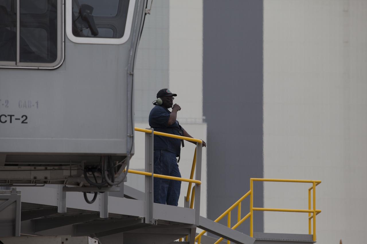 A technician communicates with the driver of NASA’s upgraded crawler-transporter 2 (CT-2) during the return drive to the Vehicle Assembly Building (VAB) at the agency’s Kennedy Space Center in Florida from its test drive to Launch Pad 39B. The crawler’s recently completed upgrades and modifications were tested to ensure the vehicle will be ready to support NASA’s journey to Mars. The Ground Systems Development and Operations Program at Kennedy oversaw upgrades to the crawler in the VAB. The crawler will carry the mobile launcher with Orion atop the Space Launch System rocket to Pad 39B for Exploration Mission 1.