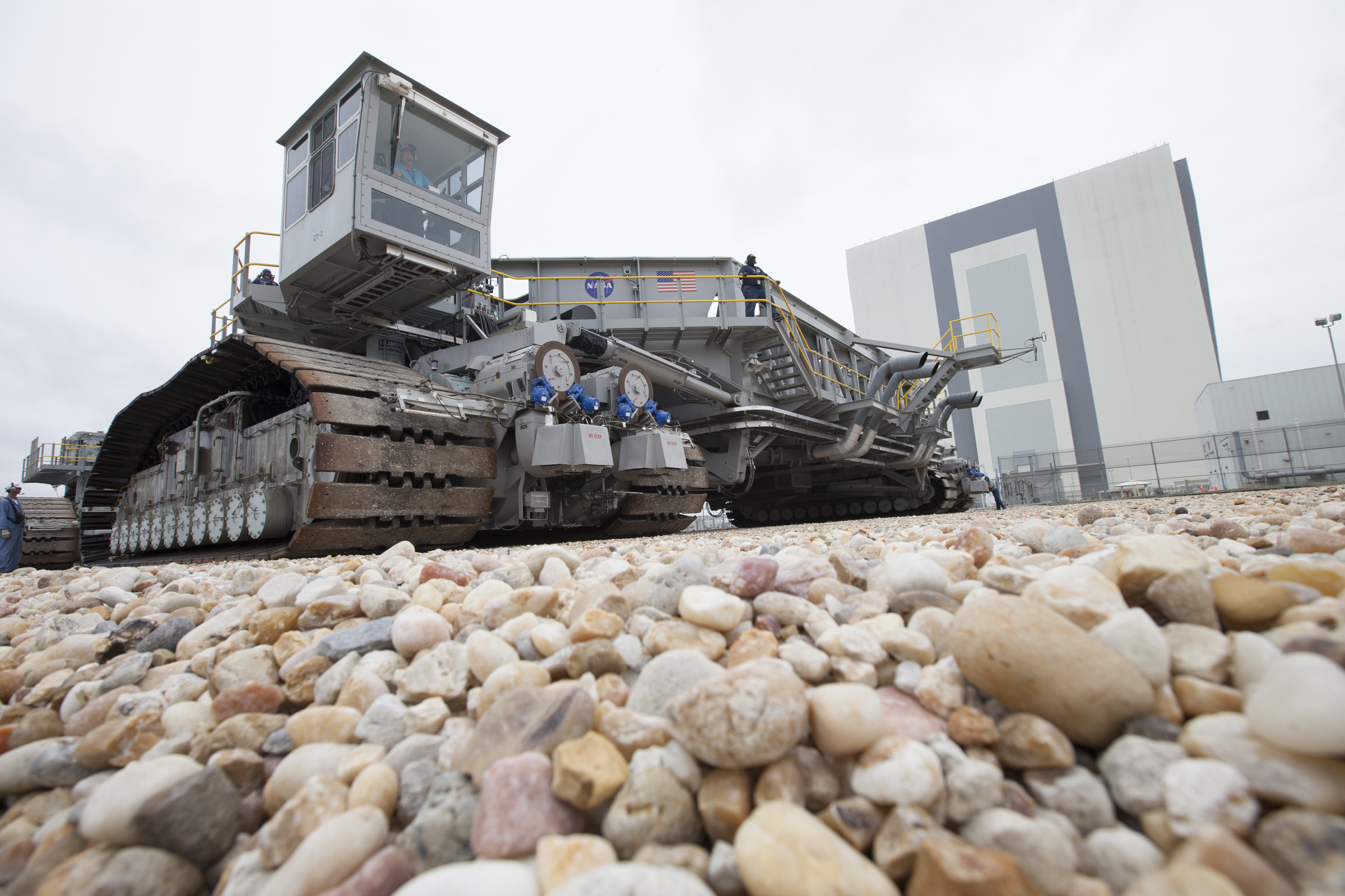Crawlerway rock is visible as NASA’s upgraded crawler-transporter 2 (CT-2) returns to the Vehicle Assembly Building (VAB) at the agency’s Kennedy Space Center in Florida from its trek to Launch Pad 39B. CT2’s recently completed upgrades and modifications were tested to ensure the vehicle will be ready to support NASA’s journey to Mars. The Ground Systems Development and Operations Program at Kennedy oversaw upgrades to the crawler in the VAB. The crawler will carry the mobile launcher with Orion atop the Space Launch System rocket to Pad 39B for Exploration Mission 1.