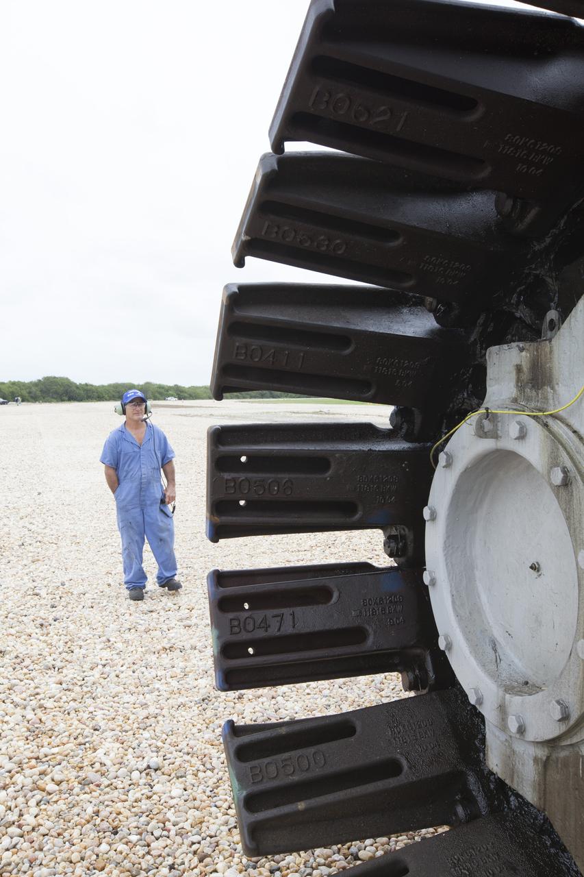 A technician watches the motion of the giant tracks on NASA’s upgraded crawler-transporter 2 (CT-2) as the giant vehicle travels along the crawlerway toward the Vehicle Assembly Building from its trek to Launch Pad 39B at the agency’s Kennedy Space Center in Florida. CT-2 was drive to Pad 39B to test recently completed upgrades and modifications to support NASA’s journey to Mars. The Ground Systems Development and Operations Program at Kennedy oversaw upgrades to the crawler in the VAB. The crawler will carry the mobile launcher with Orion atop the Space Launch System rocket to Pad 39B for Exploration Mission 1.