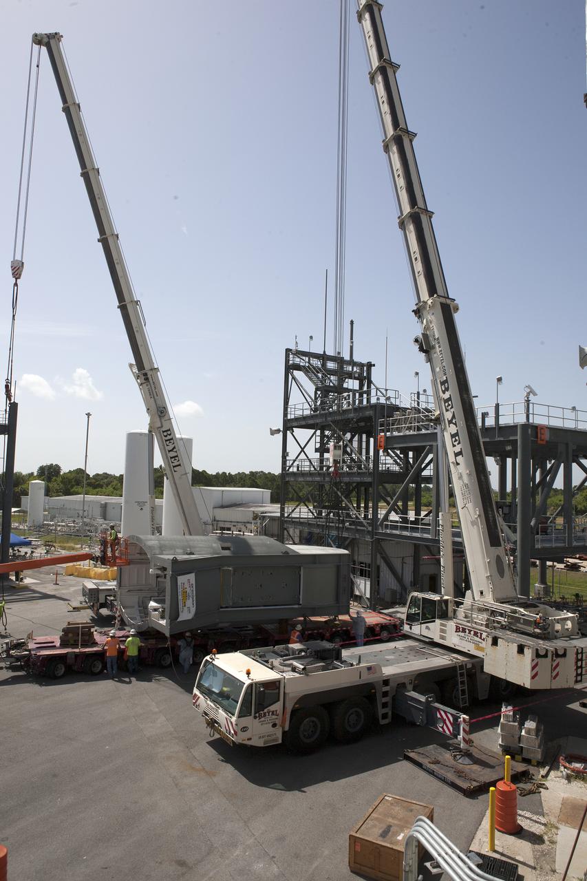 A crane is prepared to help lift the first Tail Service Mast Umbilical (TSMU) for NASA’s Space Launch System (SLS) at the Launch Equipment Test Facility (LETF) at NASA’s Kennedy Space Center in Florida. Two TSMUs will provide liquid propellants and power to the Space Launch System (SLS) rocket’s core stage engine. Both TSMUs will connect to the zero-level deck on the mobile launcher, providing fuel and electricity to the SLS rocket before it launches on Exploration Mission 1. The TSMU will undergo testing and validation at the LETF to verify it is functioning properly. The center’s Engineering Directorate and the Ground Systems Development and Operations Program are overseeing processing and testing of the umbilicals.