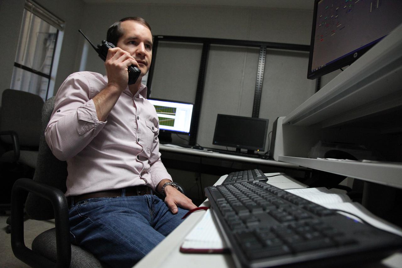 Inside a control building at NASA's Kennedy Space Center in Florida, Adam Swinger, cryogenic research engineer in the Exploration Research and Technology Directorate, communicates with team members during a test of the Ground Operations Demo Unit for liquid hydrogen. The system includes a 33,000 gallon liquid hydrogen storage tank with an internal cold heat exchanger supplied from a cryogenic refrigerator. The primary goal of the testing is to achieve a liquid hydrogen zero boil-off capability. The system was designed, installed and tested by a team of civil servants and contractors from the center's Cryogenic Test Laboratory, with support from engineers at NASA's Glenn Research Center in Cleveland and Stennis Space Center in Mississippi. It may be applicable for use by the Ground Systems Development and Operations Program at Launch Pad 39B.