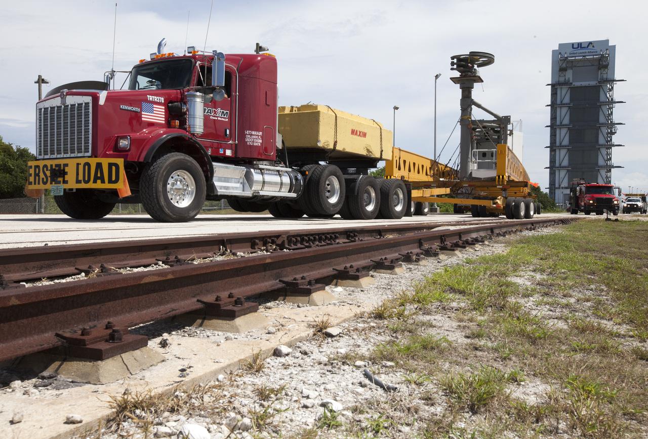 A heavy-lift transport truck, carrying the Crew Access Arm for Space Launch Complex 41, backs up toward Complex 41 at Cape Canaveral Air Force Station in Florida. The arm will be installed on the Complex 41 Crew Access Tower. It will be used as a bridge by astronauts to board Boeing's CST-100 Starliner spacecraft as it stands on the launch pad atop a United Launch Alliance Atlas V rocket.