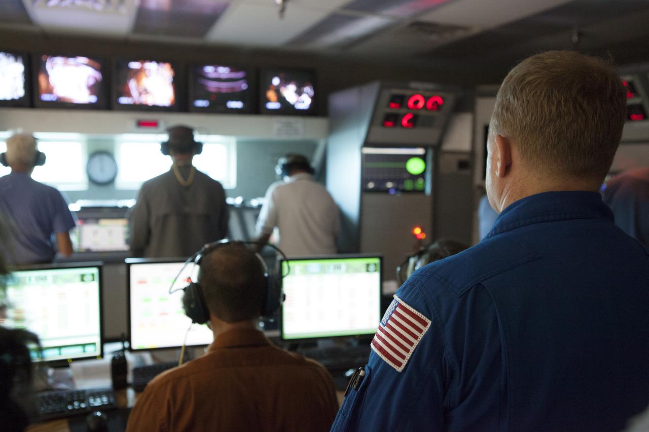 NASA astronaut Eric Boe watches as Aerojet Rocketdyne test team engineers direct the test-firing of an RL10 engine at the company's facility in West Palm Beach, Florida. The engine will be one of two used for the Centaur upper stage during a United Launch Alliance Atlas V mission to launch Boeing's CST-100 Starliner on a flight test carrying a crew. The engine was test-fired as part of acceptance testing to confirm the engine is ready for flight. 
