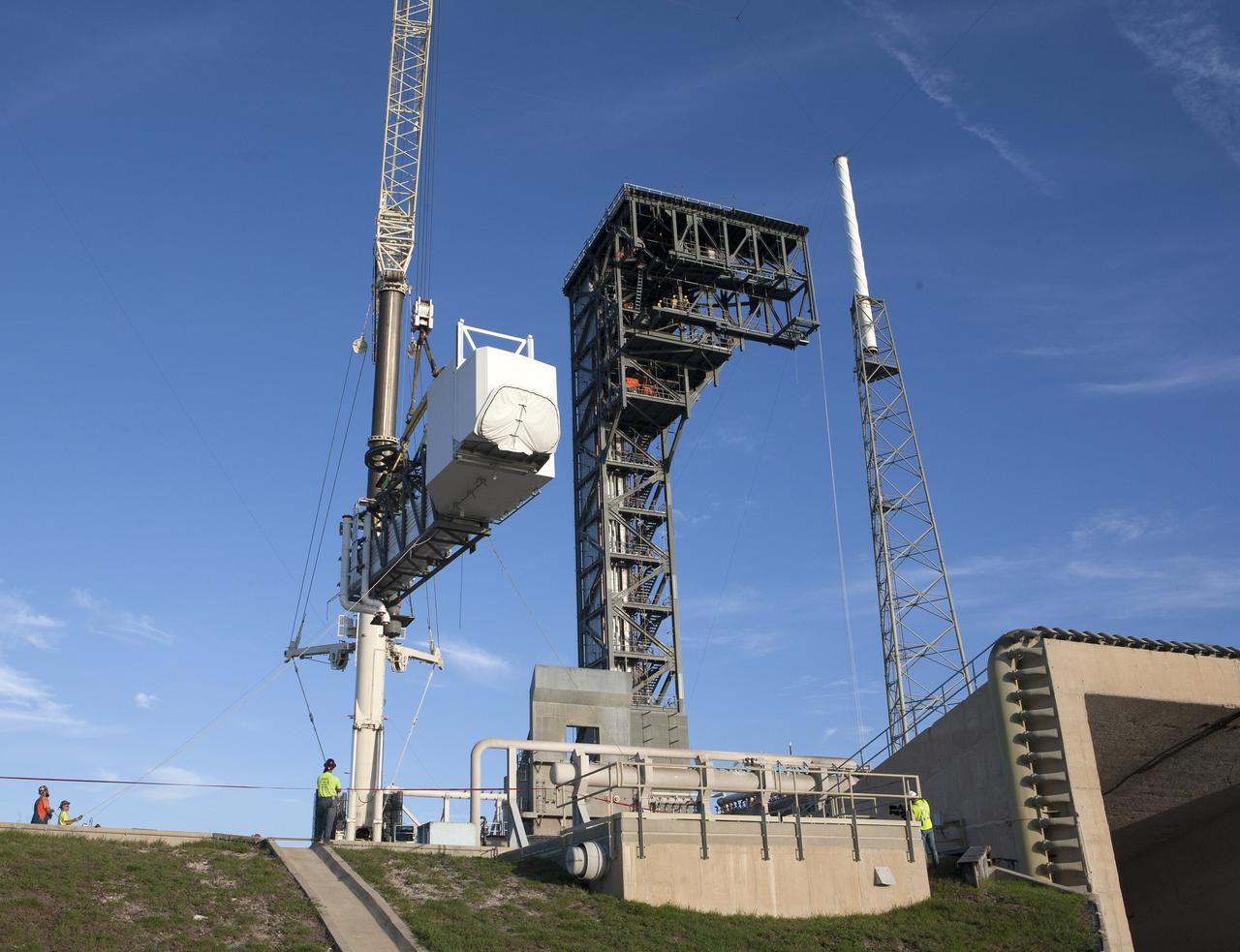 A crane lifts the Crew Access Arm and White Room for Boeing's CST-100 Starliner spacecraft to be attached to the Crew Access Tower at Cape Canaveral Air Force Station’s Space Launch Complex 41. When attached to the 200-foot tall Crew Access Tower, the arm will serve as the connection that astronauts will walk through prior to boarding the Starliner spacecraft when stacked atop a United Launch Alliance Atlas V rocket. This installation completes the major construction of the first new Crew Access Tower to be built at the Cape since the Apollo era. Under a Commercial Crew Transportation Capability (CCtCap) contract with NASA, Boeing’s Starliner system will be certified by NASA's Commercial Crew Program to fly crews to and from the International Space Station.