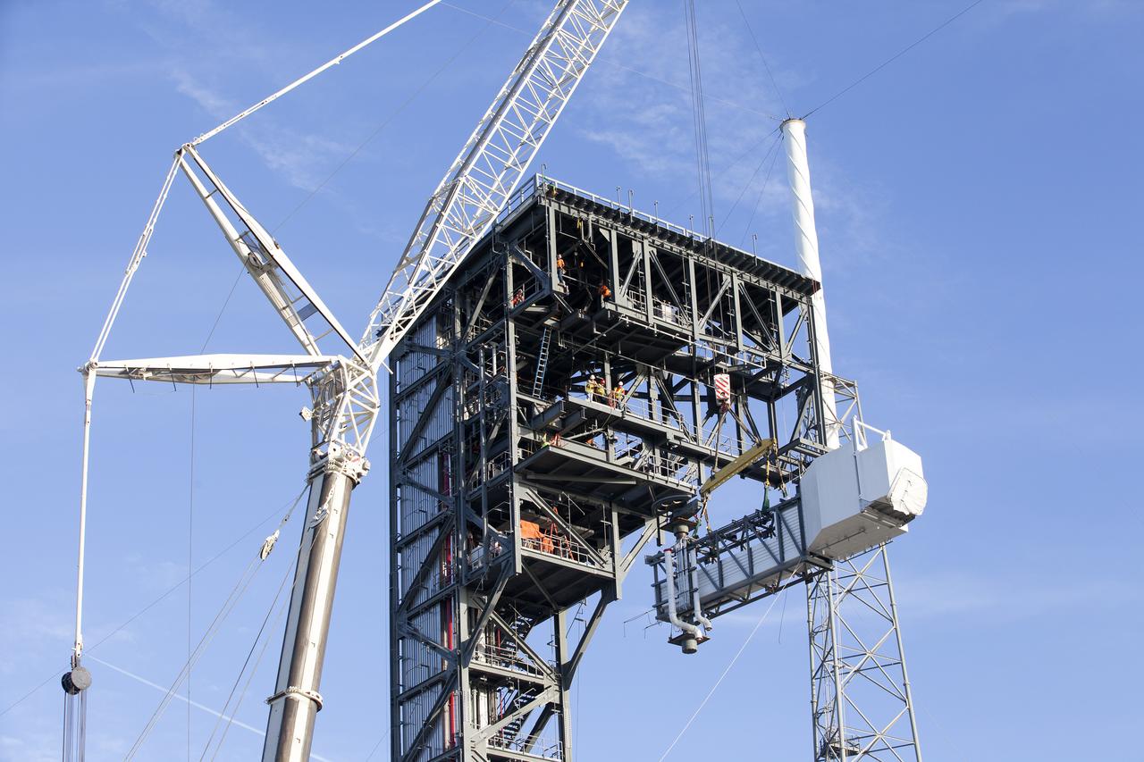 A crane lifts the Crew Access Arm and White Room for Boeing's CST-100 Starliner spacecraft to be attached to the Crew Access Tower at Cape Canaveral Air Force Station’s Space Launch Complex 41. When attached to the 200-foot tall Crew Access Tower, the arm will serve as the connection that astronauts will walk through prior to boarding the Starliner spacecraft when stacked atop a United Launch Alliance Atlas V rocket. The installation completes the major construction of the first new Crew Access Tower to be built at the Cape since the Apollo era. Under a Commercial Crew Transportation Capability (CCtCap) contract with NASA, Boeing’s Starliner system will be certified by NASA's Commercial Crew Program to fly crews to and from the International Space Station.