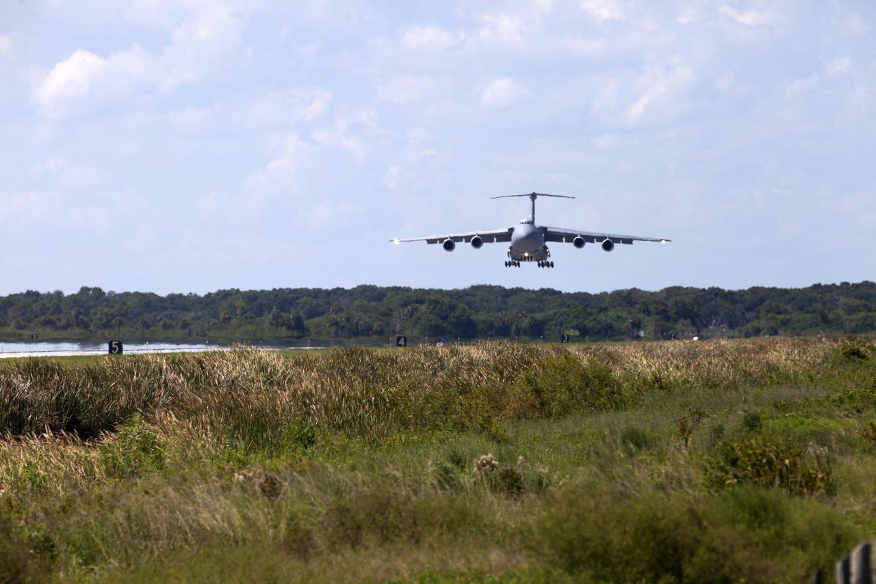 An Air Force C-5 Galaxy transport plane approaches the Shuttle Landing Facility at NASA's Kennedy Space Center in Florida to deliver the GOES-R spacecraft for launch processing. The GOES series are weather satellites operated by NOAA to enhance forecasts. The spacecraft is to launch aboard a United Launch Alliance Atlas V rocket in November.