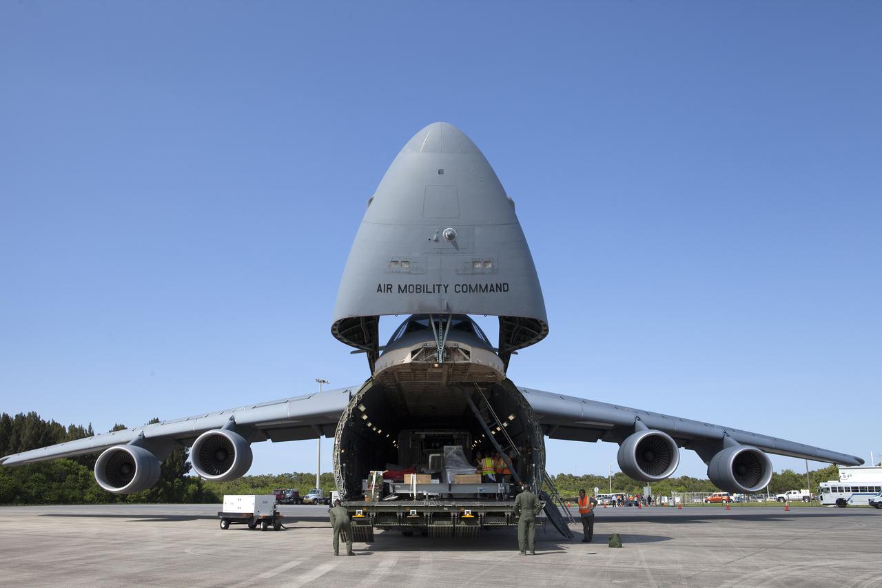 An Air Force C-5 Galaxy transport plane opens its nose section at the Shuttle Landing Facility at NASA's Kennedy Space Center in Florida to deliver the GOES-R spacecraft for launch processing. The GOES series are weather satellites operated by NOAA to enhance forecasts. The spacecraft is to launch aboard a United Launch Alliance Atlas V rocket in November.