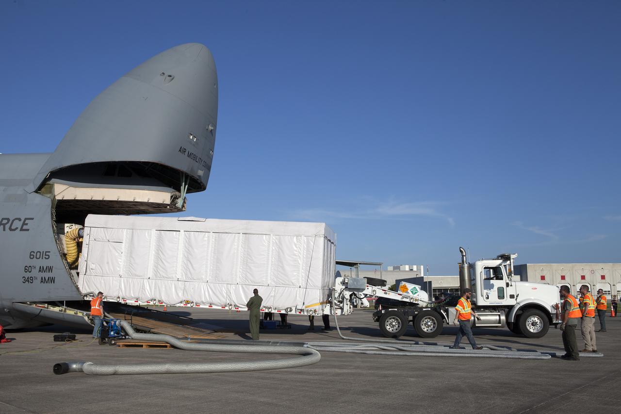 A truck with a specialized transporter drives out of the cargo hold of an Air Force C-5 Galaxy transport plane at the Shuttle Landing Facility at NASA's Kennedy Space Center in Florida to deliver the GOES-R spacecraft for launch processing. The GOES series are weather satellites operated by NOAA to enhance forecasts. The spacecraft is to launch aboard a United Launch Alliance Atlas V rocket in November.