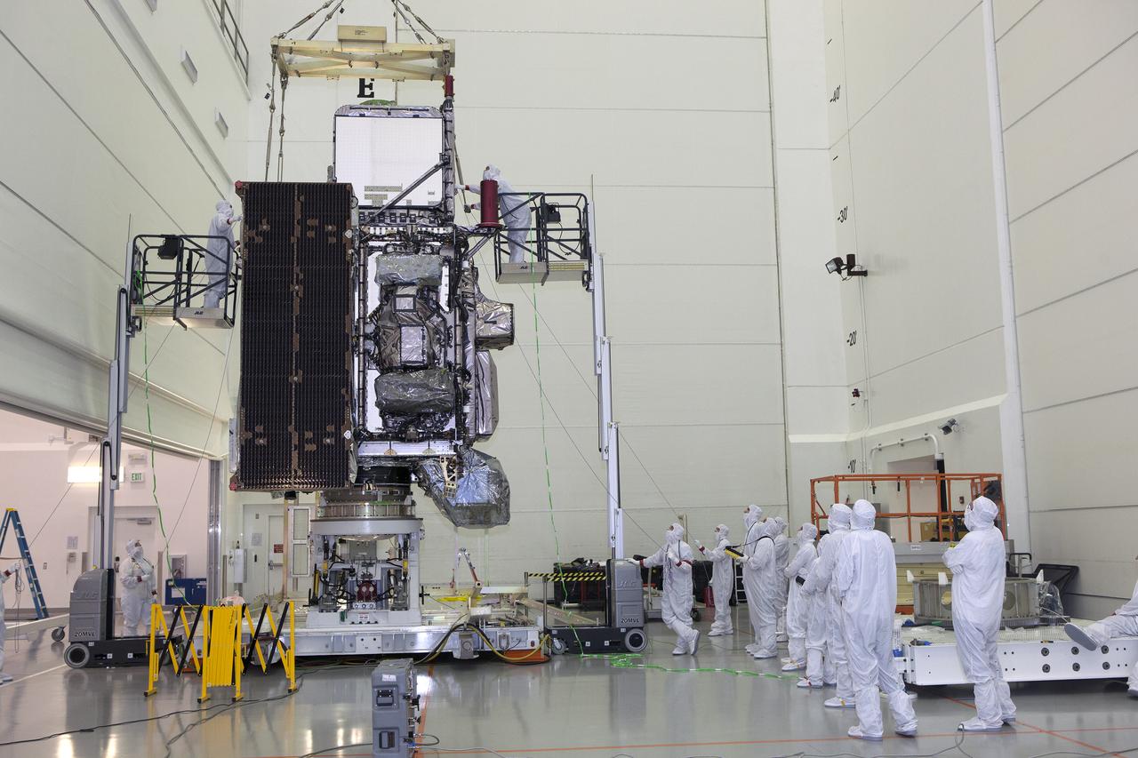 An overhead crane lifts the GOES-R spacecraft to move it into its work stand inside the Astrotech payload processing facility in Titusville, Florida near NASA’s Kennedy Space Center. GOES-R will be the first satellite in a series of next-generation NOAA Geostationary Operational Environmental Satellites. The spacecraft is to launch aboard a United Launch Alliance Atlas V rocket in November.