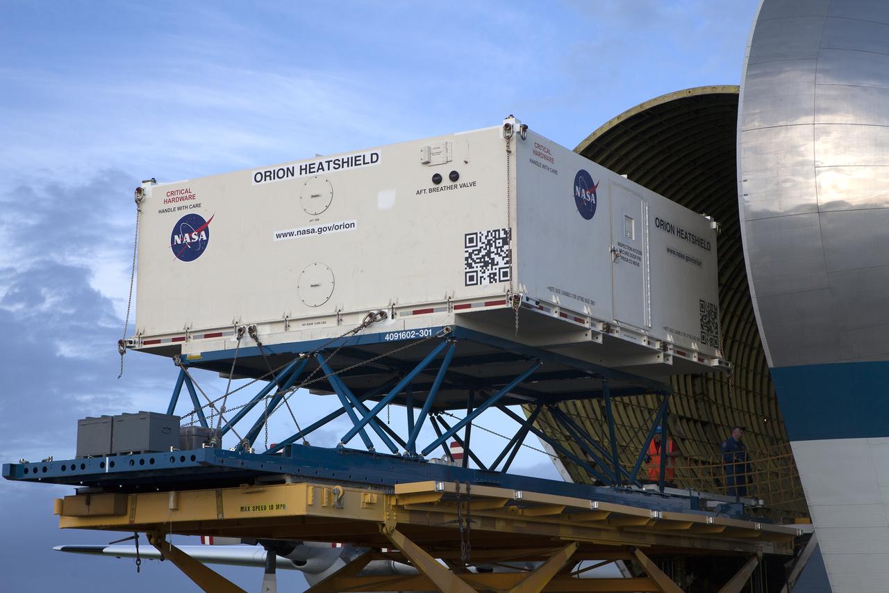 The shipping container carrying the Orion heat shield for Exploration Mission 1 (EM-1) is offloaded from NASA’s Super Guppy aircraft at the Shuttle Landing Facility, managed and operated by Space Florida, at the agency’s Kennedy Space Center in Florida. The heat shield will be transported to the Neil Armstrong Operations and Checkout Building high bay for processing. The heat shield arrived from Lockheed Martin’s manufacturing facility near Denver. The Orion spacecraft will launch atop NASA’s Space Launch System rocket on EM-1, an uncrewed test flight, in 2018. 