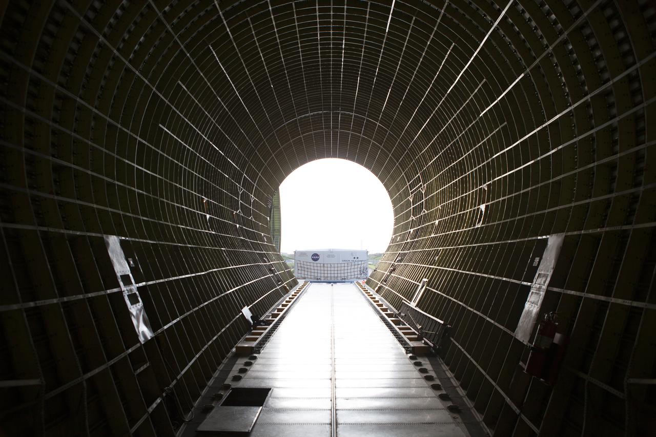 A view from inside the cargo bay of NASA’s Super Guppy aircraft reveals that the shipping container with the Orion heat shield for Exploration Mission 1 (EM-1) was offloaded at the Shuttle Landing Facility, managed and operated by Space Florida, at the agency’s Kennedy Space Center in Florida. The heat shield will be transported to the Neil Armstrong Operations and Checkout Building high bay for processing. The heat shield arrived from Lockheed Martin’s manufacturing facility near Denver. The Orion spacecraft will launch atop NASA’s Space Launch System rocket on EM-1, an uncrewed test flight, in 2018.