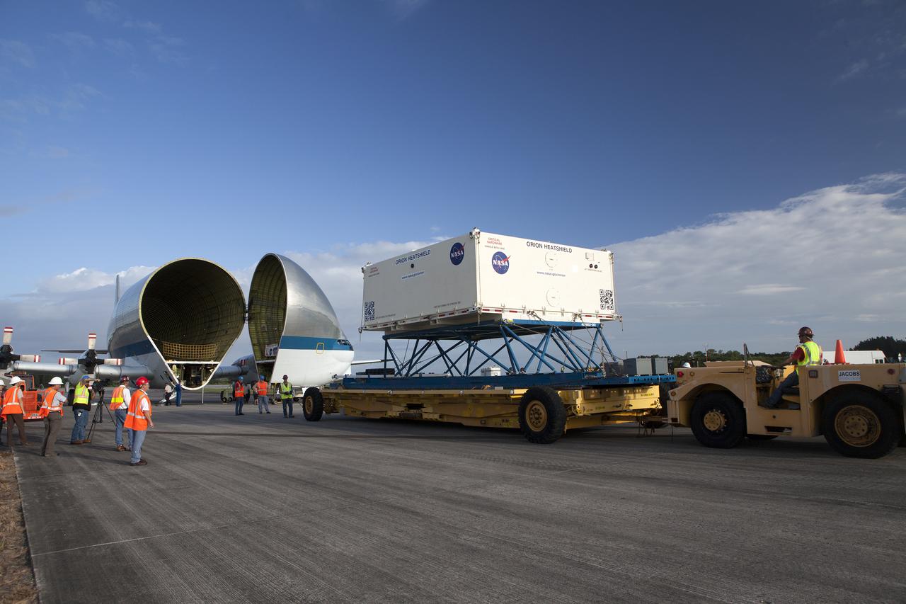 The shipping container carrying the Orion heat shield for Exploration Mission 1 (EM-1) was offloaded from NASA’s Super Guppy aircraft at the Shuttle Landing Facility, managed and operated by Space Florida, at the agency’s Kennedy Space Center in Florida. The heat shield will be transported to the Neil Armstrong Operations and Checkout Building high bay for processing. The heat shield arrived from Lockheed Martin’s manufacturing facility near Denver. The Orion spacecraft will launch atop NASA’s Space Launch System rocket on EM-1, an uncrewed test flight, in 2018.