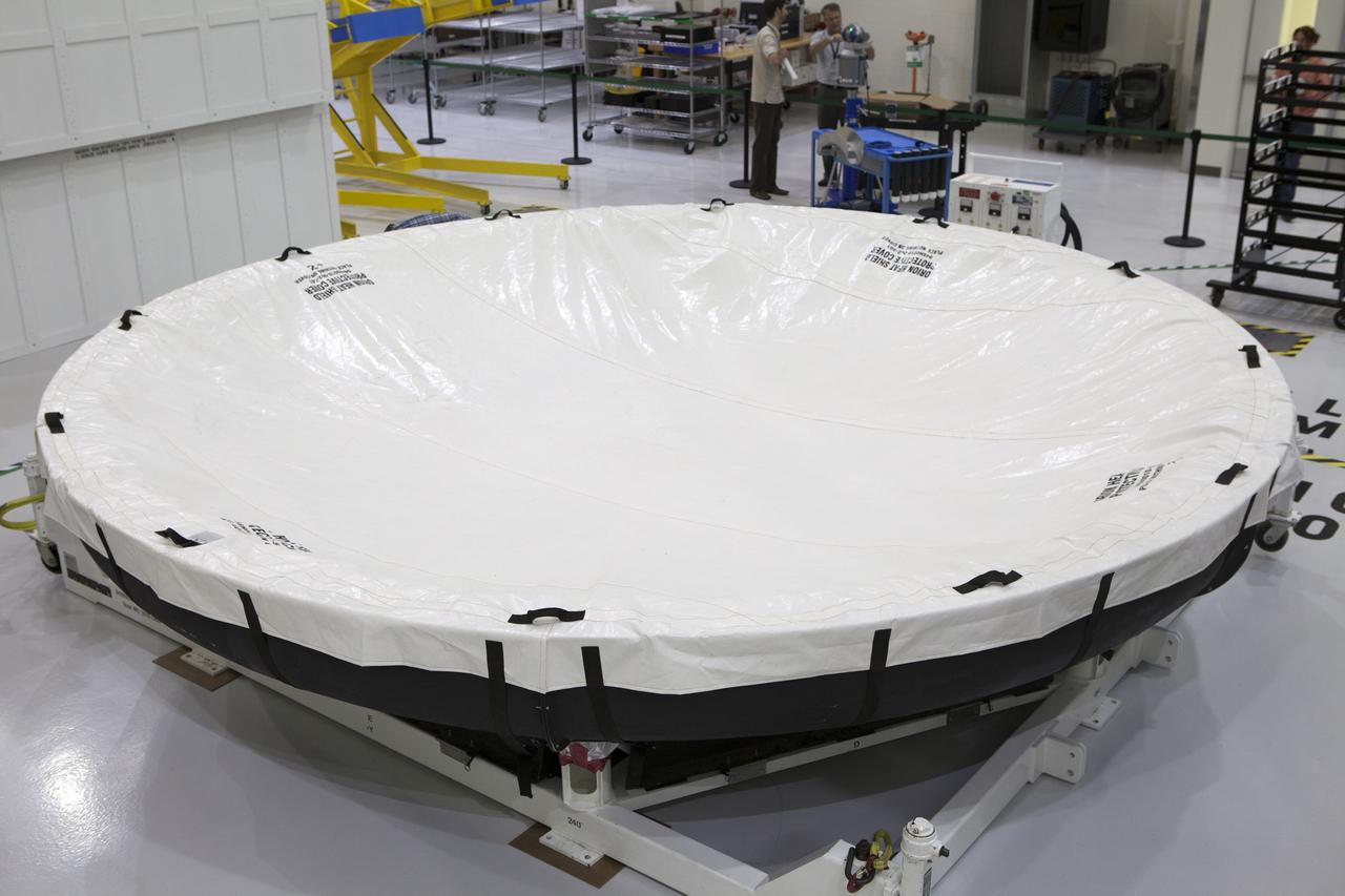The Orion heat shield for Exploration Mission 1 (EM-1) is secured inside the Neil Armstrong Operations and Checkout Building high bay at NASA’s Kennedy Space Center in Florida. The heat shield arrived aboard the agency’s Super Guppy aircraft at the Shuttle Landing Facility, managed and operated by Space Florida, from Lockheed Martin’s manufacturing facility near Denver. The heat shield will be moved onto a test stand to begin processing. The Orion spacecraft will launch atop NASA’s Space Launch System rocket on EM-1, an uncrewed test flight, in 2018. 