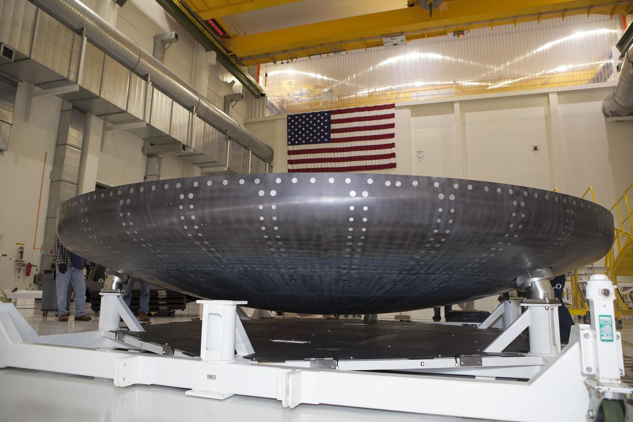 Inside the high bay in the Neil Armstrong Operations and Checkout Building at NASA’s Kennedy Space Center in Florida, the protective coverings were removed from the Orion heat shield for Exploration Mission 1 (EM-1). The heat shield arrived aboard NASA’s Super Guppy aircraft at the Shuttle Landing Facility, managed and operated by Space Florida, from Lockheed Martin’s manufacturing facility near Denver. The Orion spacecraft will launch atop NASA’s Space Launch System rocket on EM-1, an uncrewed test flight, targeted for November 2018. 
