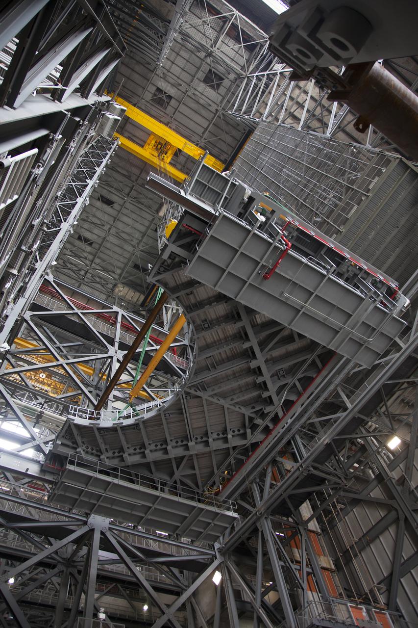 A heavy-lift crane lifts the first half of the E-level work platforms, E south, for NASA’s Space Launch System (SLS) rocket, up from the floor of the Vehicle Assembly Building (VAB) at NASA’s Kennedy Space Center in Florida. The E platform will be installed on the south side of High Bay 3, about 246 feet above the floor. The E platforms are the sixth of 10 levels of work platforms that will surround and provide access to the SLS rocket and Orion spacecraft for Exploration Mission 1. The Ground Systems Development and Operations Program is overseeing upgrades and modifications to VAB High Bay 3, including installation of the new work platforms, to prepare for NASA’s journey to Mars.