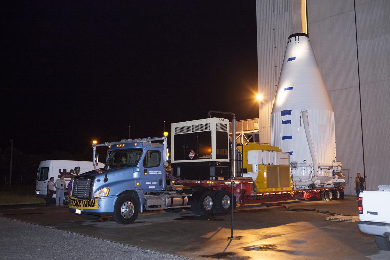 The OSIRIS-REx spacecraft, enclosed in a payload fairing, is towed from the Payload Hazardous Servicing Facility at NASA's Kennedy Space Center to begin the trip to Space Launch Complex 41 at the adjacent Cape Canaveral Air Force Station. The United Launch Alliance Atlas V rocket that is to lift OSIRIS-REx into space was stacked at SLC-41 so the spacecraft and fairing could be hoisted and bolted to the rocket promptly. The spacecraft will be sent to rendezvous with, survey and take a sample from an asteroid called Bennu.