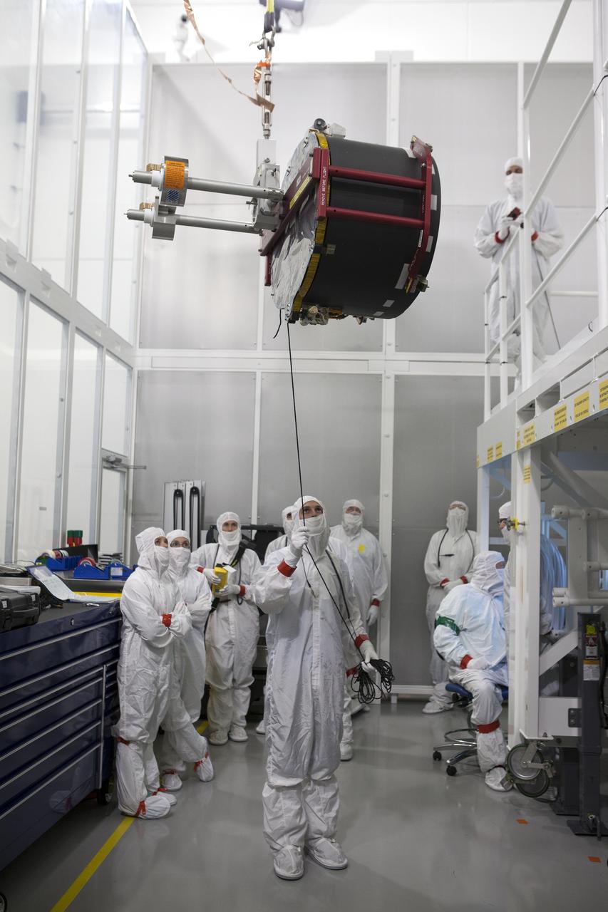Team members assist as a crane lifts the Advanced Base Line Imager, the primary optical instrument, for installation on the Geostationary Operational Environmental Satellite (GOES-R) inside the Astrotech payload processing facility in Titusville, Florida near NASA’s Kennedy Space Center. GOES-R will be the first satellite in a series of next-generation NOAA GOES Satellites. The spacecraft is to launch aboard a United Launch Alliance Atlas V rocket in November.