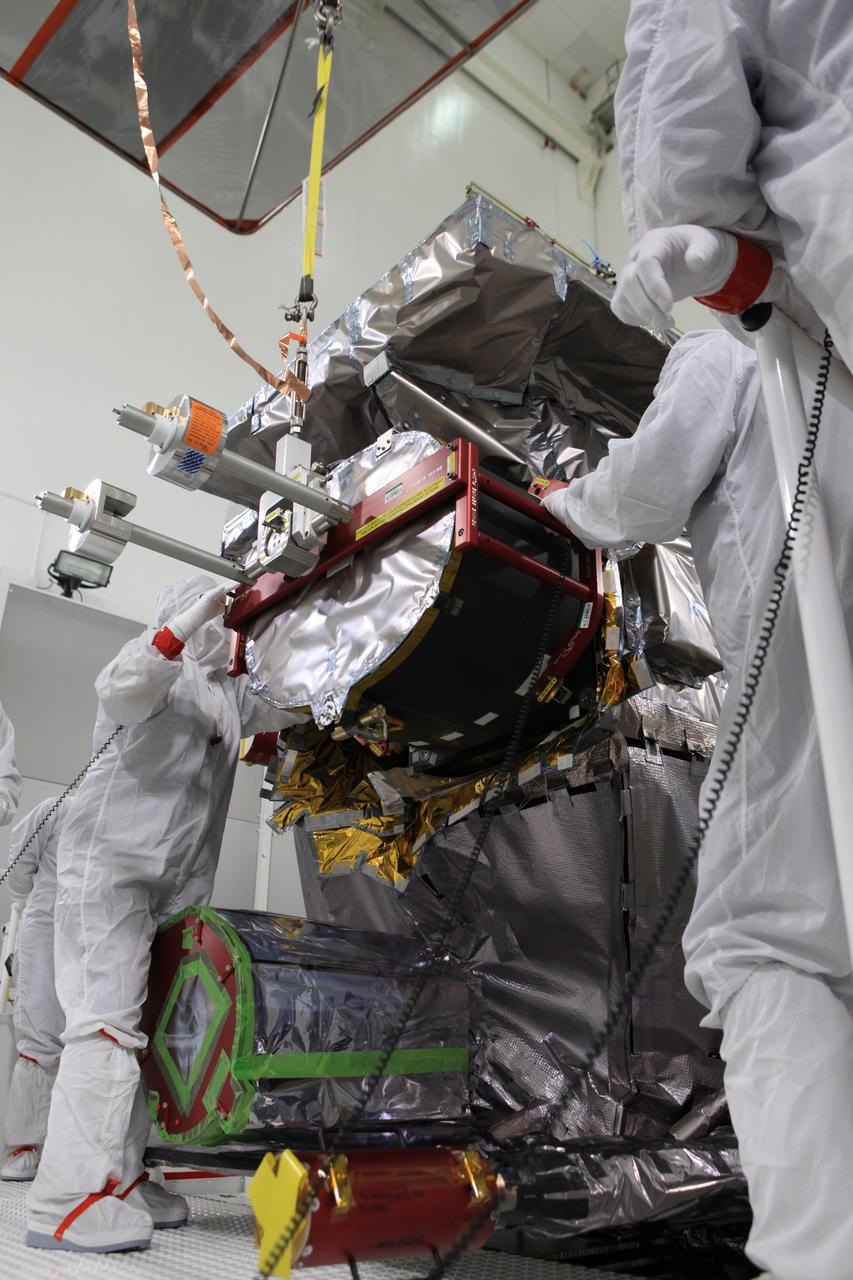 Team members install the Advanced Base Line Imager, the primary optical instrument, on the Geostationary Operational Environmental Satellite (GOES-R) inside the Astrotech payload processing facility in Titusville, Florida near NASA’s Kennedy Space Center. GOES-R will be the first satellite in a series of next-generation NOAA GOES Satellites. The spacecraft is to launch aboard a United Launch Alliance Atlas V rocket in November.