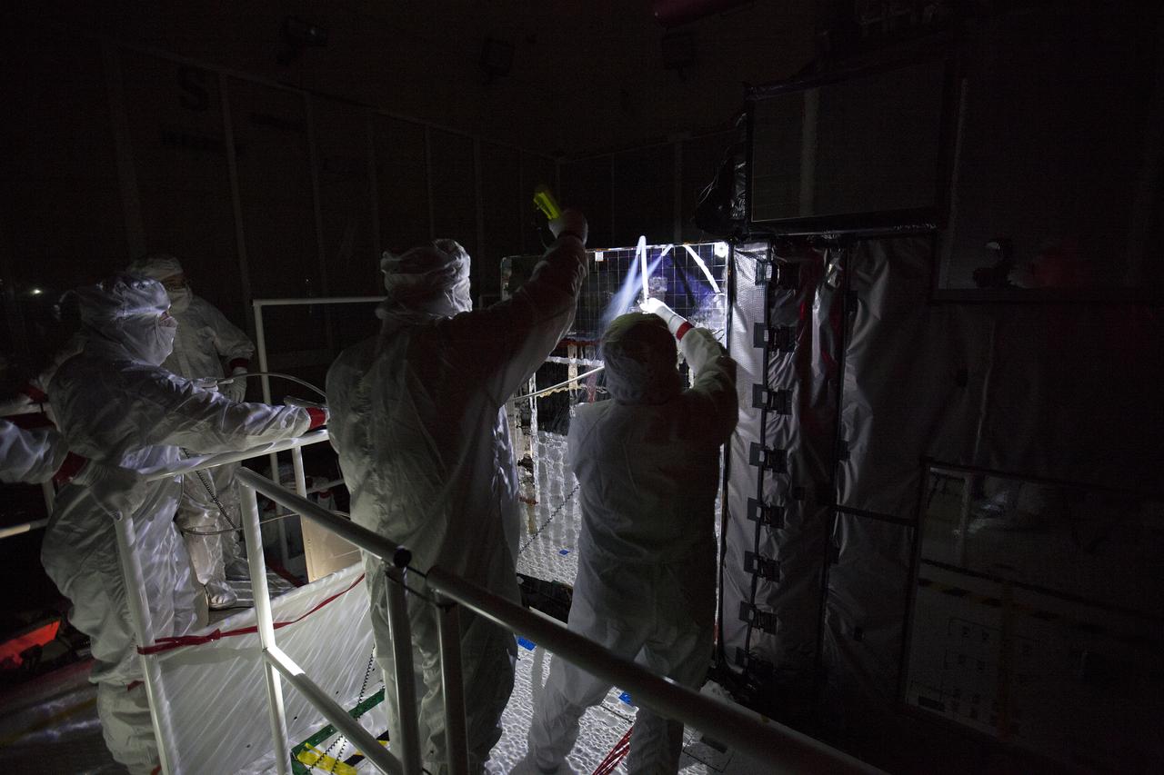 With the lights out, team members perform an optics test on the Advanced Baseline Imager, the primary optical instrument, on the Geostationary Operational Environmental Satellite (GOES-R) inside the Astrotech payload processing facility in Titusville, Florida near NASA’s Kennedy Space Center. Carbon dioxide is sprayed on the imager to clean it and test its sensitivity. GOES-R will be the first satellite in a series of next-generation NOAA GOES Satellites. The spacecraft is to launch aboard a United Launch Alliance Atlas V rocket in November. 