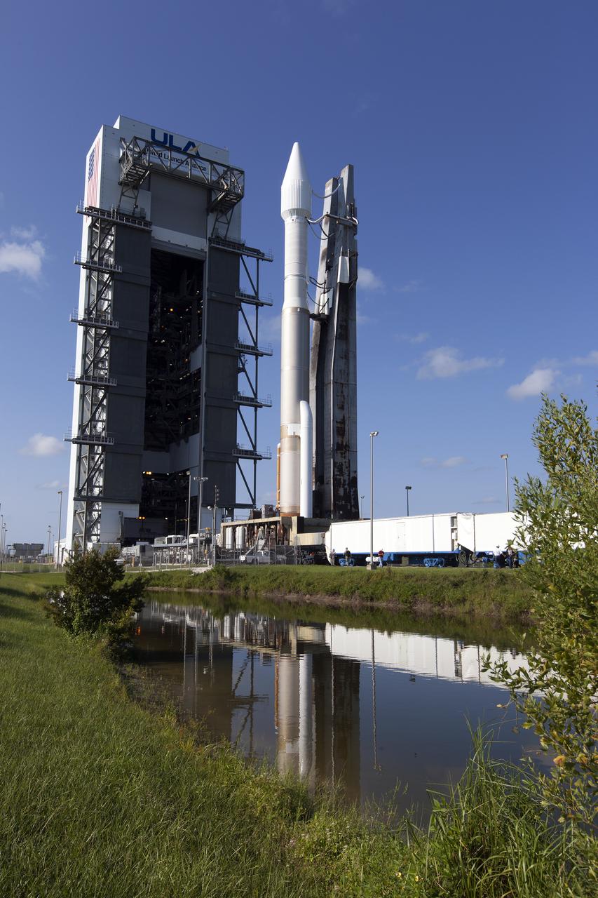 A United Launch Alliance Atlas V rocket is reflected in the water as it rolls out of the Vertical Integration Facility on its way to Space Launch Complex 41 at Cape Canaveral Air Force Station in Florida. The launch vehicle will boost NASA’s Origins, Spectral Interpretation, Resource Identification, Security-Regolith Explorer, or OSIRIS-REx spacecraft. This will be the first U.S. mission to sample an asteroid, retrieve at least two ounces of surface material and return it to Earth for study. The asteroid, Bennu, may hold clues to the origin of the solar system and the source of water and organic molecules found on Earth. 