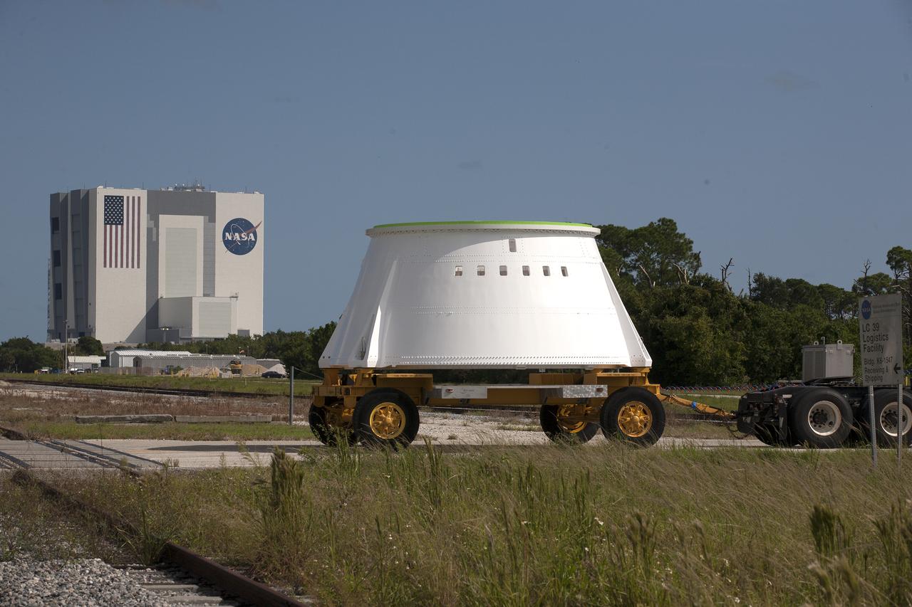 The left hand aft skirt for NASA’s Space Launch System (SLS) rocket arrives at the agency’s Kennedy Space Center in Florida, from the Hangar AF facility at Cape Canaveral Air Force Station. The aft skirt will be transported to the Booster Fabrication Facility. The space shuttle-era aft skirt, was inspected, resurfaced, primed and painted for use on the left hand booster of the SLS rocket for Exploration Mission 1 (EM-1). NASA is preparing for EM-1, deep-space missions, and the journey to Mars.