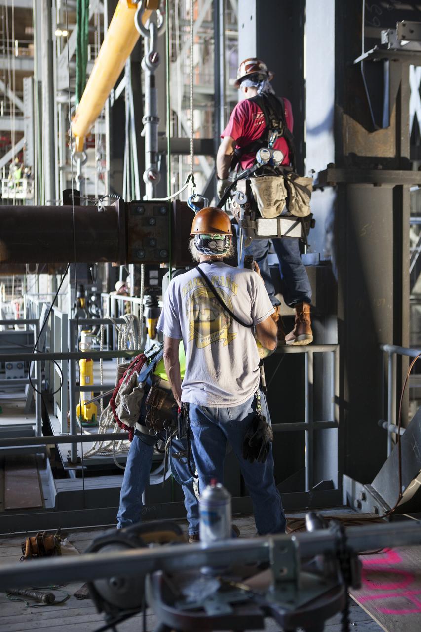 Construction workers use specialized tools to help secure the second half of the D-level work platforms, D north, for NASA’s Space Launch System (SLS) rocket, into position in High Bay 3 in the Vehicle Assembly Building (VAB) at the agency’s Kennedy Space Center in Florida. The D platform is being installed on the north side of the high bay. The D platforms are the seventh of 10 levels of work platforms that will surround and provide access to the SLS rocket and Orion spacecraft for Exploration Mission 1. The Ground Systems Development and Operations Program is overseeing upgrades and modifications to VAB High Bay 3, including installation of the new work platforms, to prepare for NASA’s journey to Mars. 