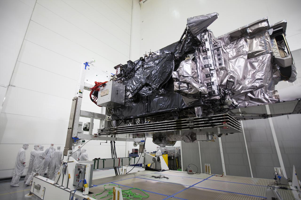 Team members assist as the Geostationary Operational Environmental Satellite (GOES-R) is prepared for lifting to the vertical position on an “up-ender” inside the Astrotech payload processing facility in Titusville, Florida near NASA’s Kennedy Space Center. GOES-R will be the first satellite in a series of next-generation NOAA GOES Satellites. The spacecraft is to launch aboard a United Launch Alliance Atlas V rocket in November. 