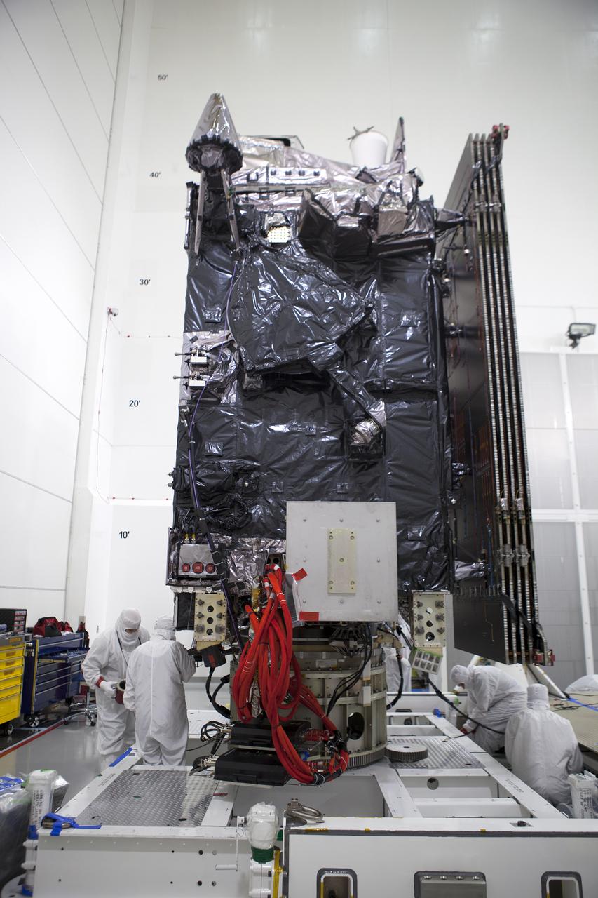 Team members check the Geostationary Operational Environmental Satellite (GOES-R) after it was lifted to the vertical position on an “up-ender” inside the Astrotech payload processing facility in Titusville, Florida near NASA’s Kennedy Space Center. GOES-R will be the first satellite in a series of next-generation NOAA GOES Satellites. The spacecraft is to launch aboard a United Launch Alliance Atlas V rocket in November.