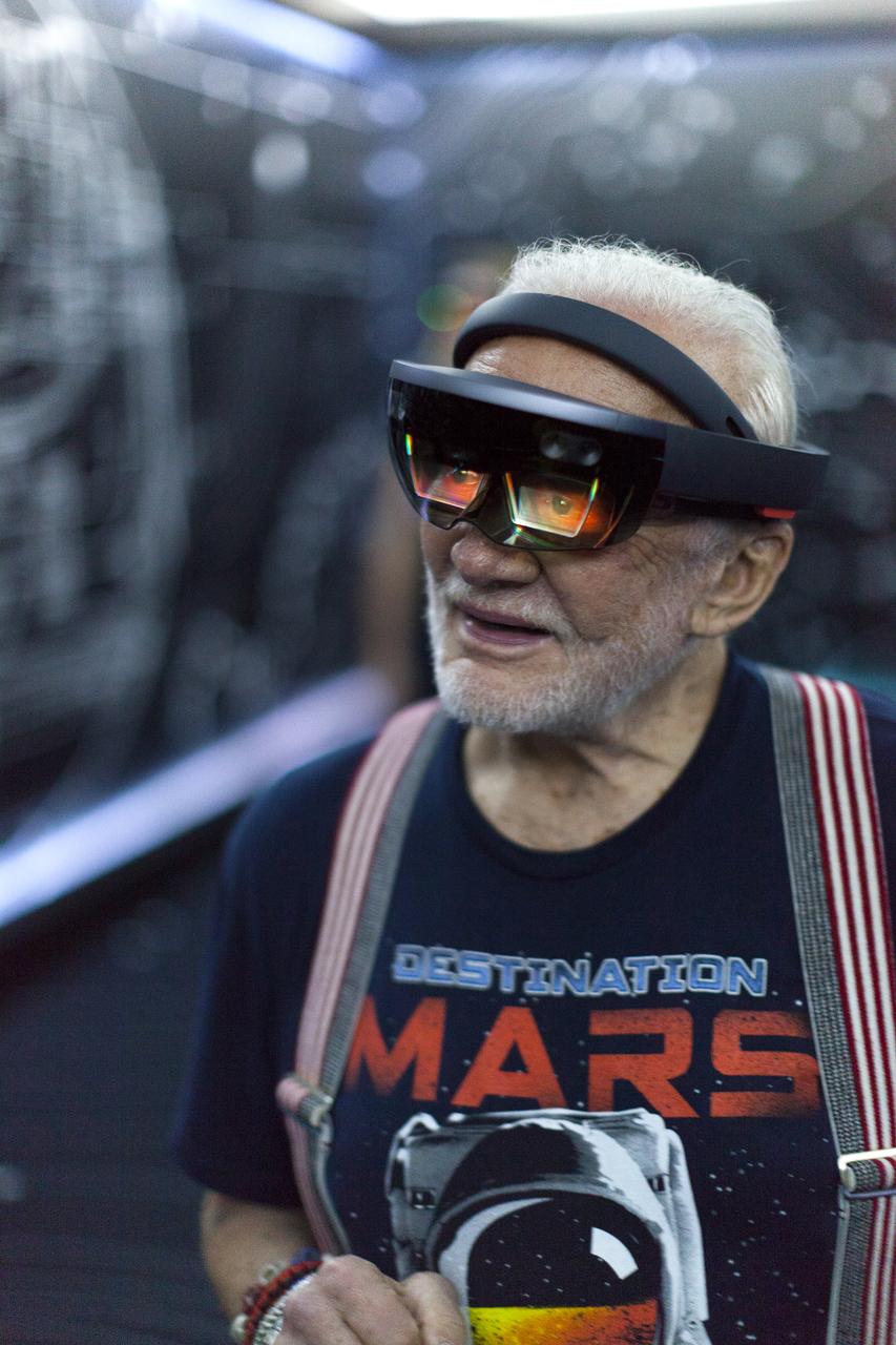 Apollo 11 astronaut Buzz Aldrin tries out Microsoft HoloLens mixed reality headset during a preview of the new Destination: Mars experience at the Kennedy Space Center Visitor Complex. Destination: Mars gives guests an opportunity to “visit” several sites on Mars using real imagery from NASA’s Curiosity Mars Rover. Based on OnSight, a tool created by NASA’s Jet Propulsion Laboratory in Pasadena, California, the experience brings guests together with a holographic version of Aldrin as they are guided to Mars using the headset. Photo credit: NASA/Charles Babir