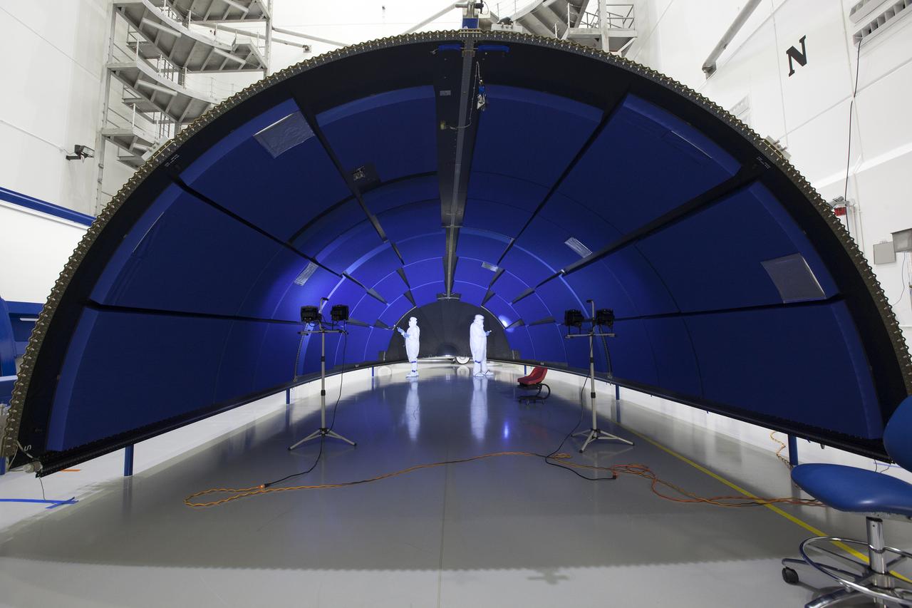 Team members with United Launch Alliance (ULA) inspect an clean the first half of the fairing for the Geostationary Operational Environmental Satellite (GOES-R) inside the Astrotech payload processing facility in Titusville, Florida near NASA’s Kennedy Space Center. GOES-R will be the first satellite in a series of next-generation NOAA GOES Satellites. The spacecraft is to launch aboard a ULA Atlas V rocket in November. 