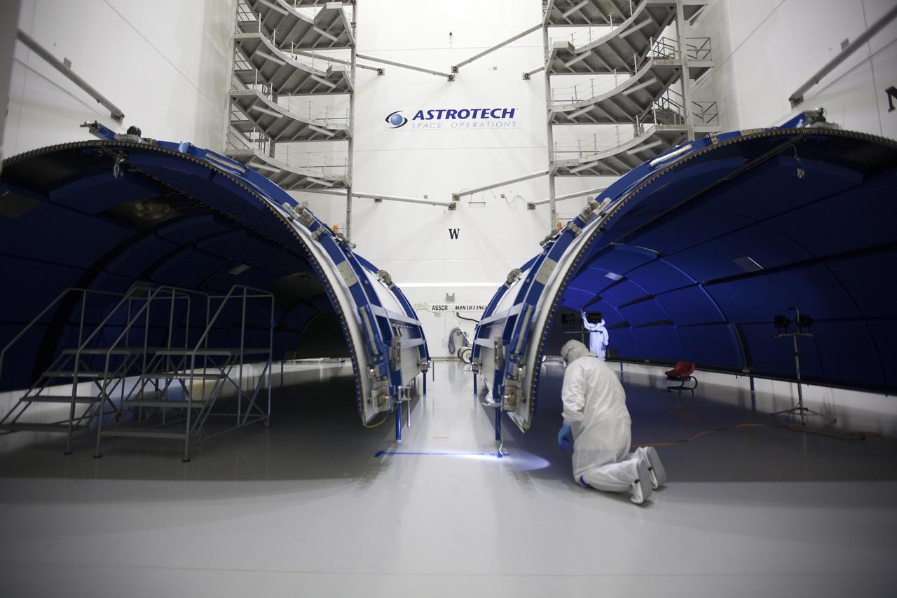 Team members with United Launch Alliance (ULA) inspect the first half of the fairing for the Geostationary Operational Environmental Satellite (GOES-R) inside the Astrotech payload processing facility in Titusville, Florida near NASA’s Kennedy Space Center. GOES-R will be the first satellite in a series of next-generation NOAA GOES Satellites. The spacecraft is to launch aboard a ULA Atlas V rocket in November. 