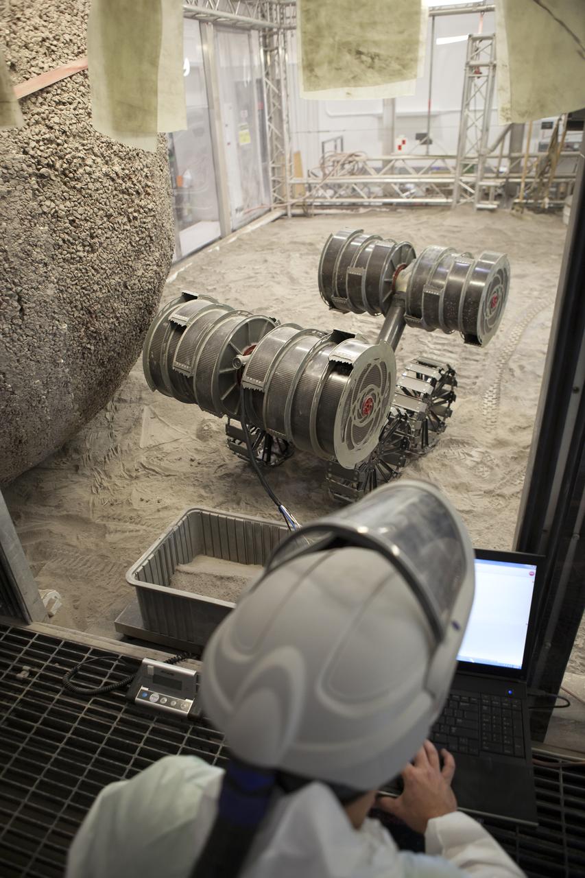 An integrated test of the MARCO POLO/Mars Pathfinder in-situ resource utilization, or ISRU, system takes place at NASA’s Kennedy Space Center in Florida. A mockup of MARCO POLO, an ISRU propellant production technology demonstration simulated mission, is tested in a regolith bin with RASSOR 2.0, the Regolith Advanced Surface Systems Operations Robot.  On the surface of Mars, mining robots like RASSOR will dig down into the regolith and take the material to a processing plant where usable elements such as hydrogen, oxygen and water can be extracted for life support systems. Regolith also shows promise for both construction and creating elements for rocket fuel.