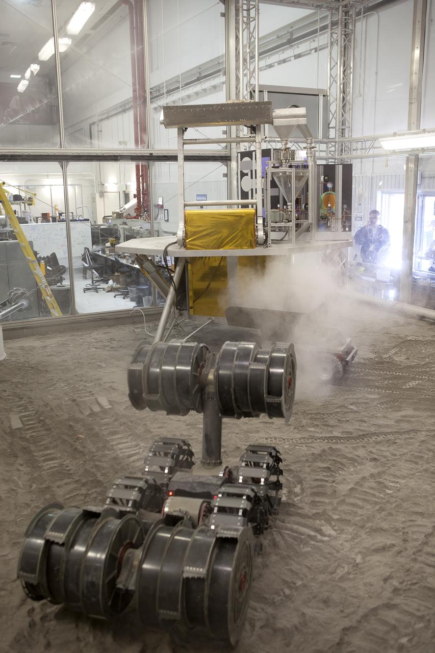An integrated test of the MARCO POLO/Mars Pathfinder in-situ resource utilization, or ISRU, system takes place at NASA’s Kennedy Space Center in Florida. A mockup of MARCO POLO, an ISRU propellant production technology demonstration simulated mission, is tested in a regolith bin with RASSOR 2.0, the Regolith Advanced Surface Systems Operations Robot.  On the surface of Mars, mining robots like RASSOR will dig down into the regolith and take the material to a processing plant where usable elements such as hydrogen, oxygen and water can be extracted for life support systems. Regolith also shows promise for both construction and creating elements for rocket fuel.